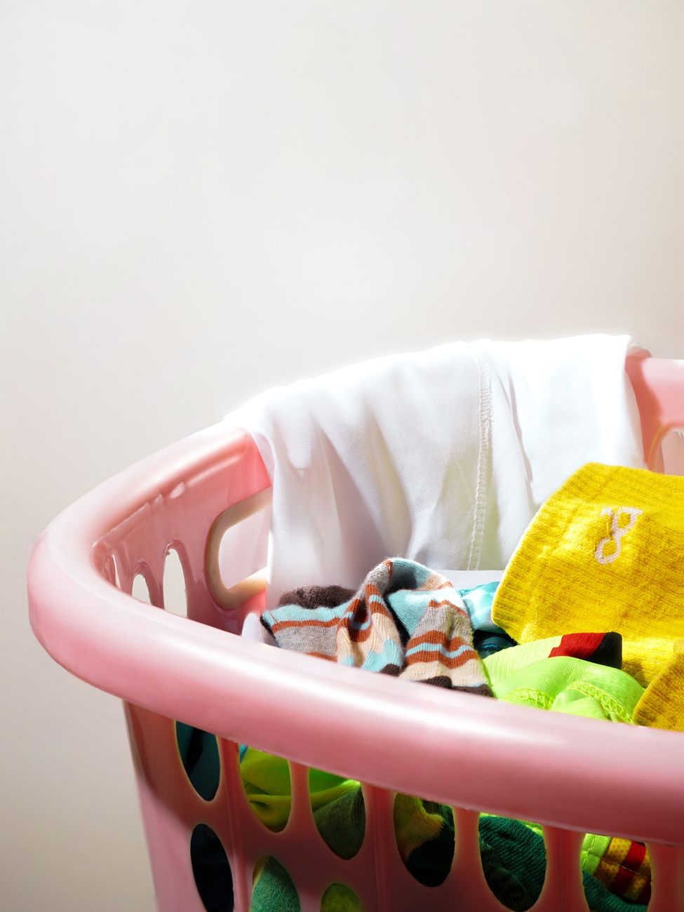 colorful laundry basket with mixed clothes